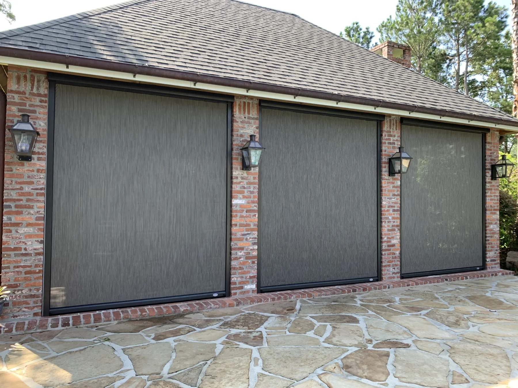 Brick outdoor living room with three motorized patio screen openings