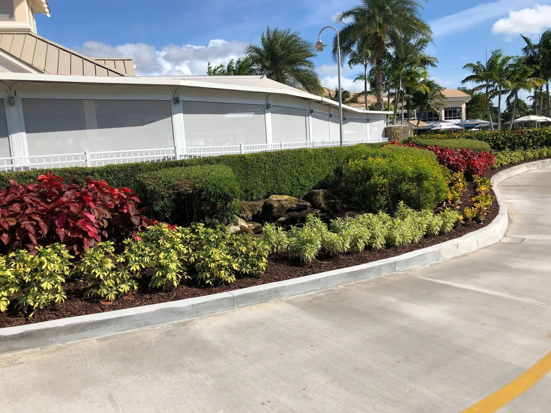Tropical resort patio with white solar screens