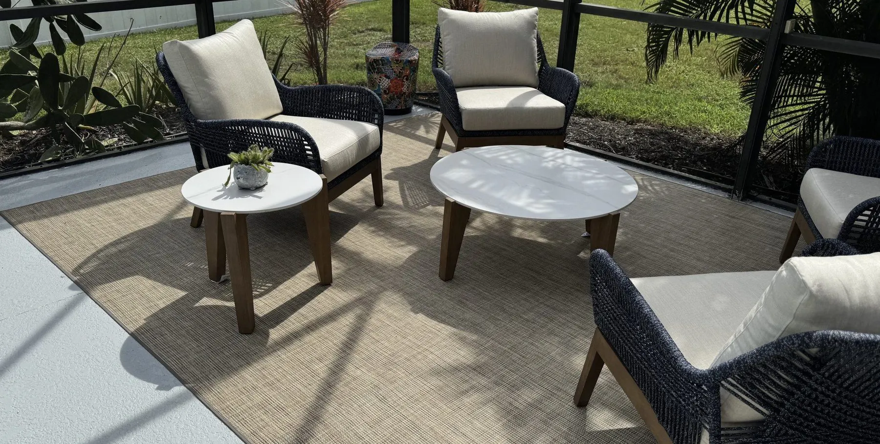 Infinity outdoor rug under patio furniture in a screened outdoor room