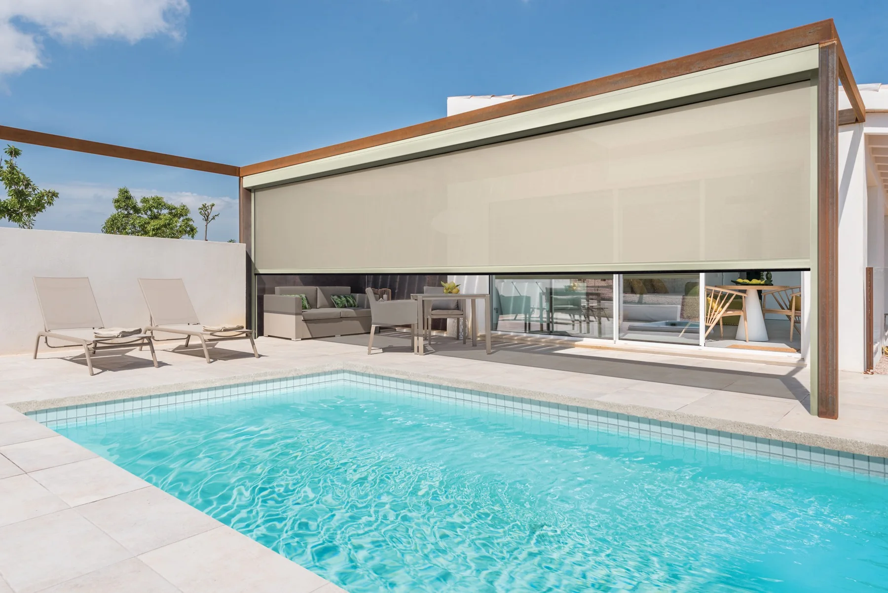 Modern pool patio with a large motorized solar patio shade lowered