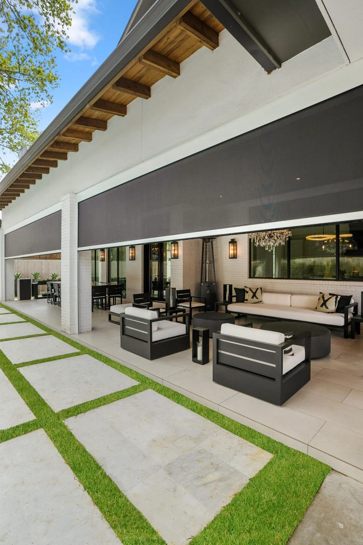 Modern covered patio with wide dark motorized shades